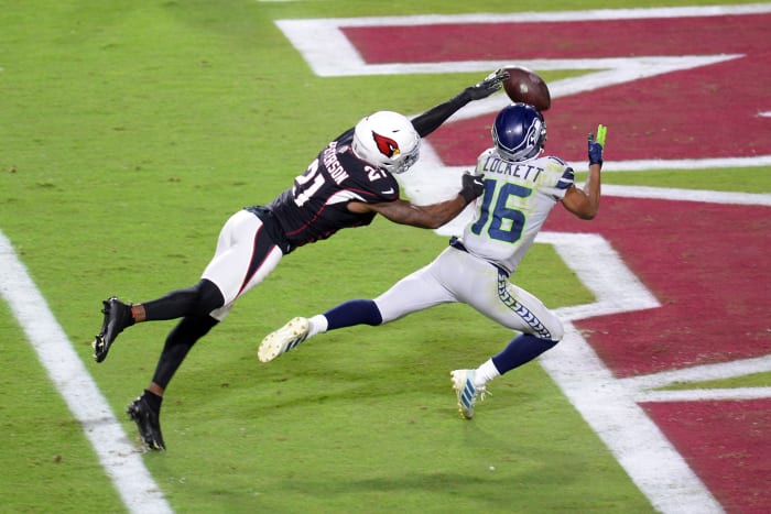 Tyler Lockett reels in a touchdown pass barely out of Cardinals cornerback Patrick Peterson's reach.